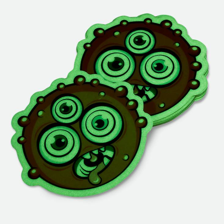 A stack of monster shaped glow in the dark stickers printed by StickerGiant
