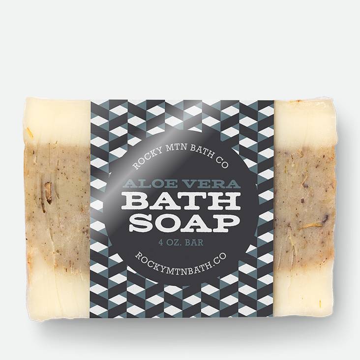 A bar of soap with Bath Soap glossy paper label printed by StickerGiant wrapped around the soap