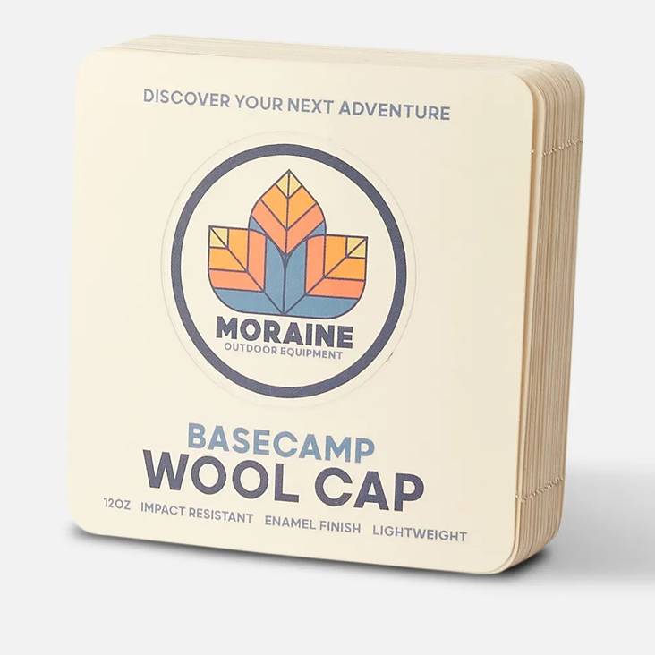 A stack of Moraine Outdoor Equipment wool cap sticker sheets printed by StickerGiant with a circular peel away sticker in the middle of the sheet